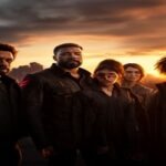 Marvel movie cast standing together in front of a city skyline at sunset